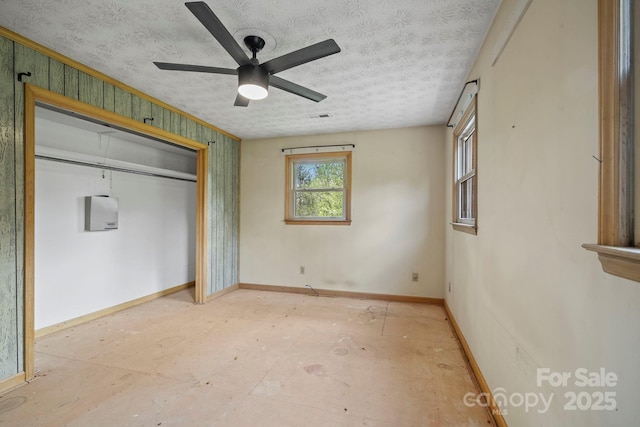 1 Ola Dr, Candler, NC 28715 - unfurnished bedroom featuring baseboards, a closet, a ceiling fan, and a textured ceiling
