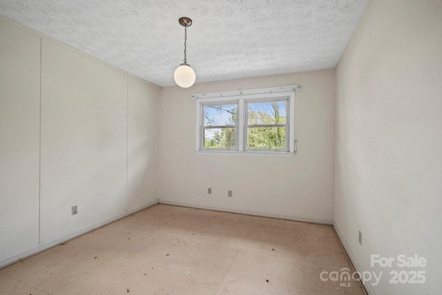 1 Ola Dr, Candler, NC 28715 - unfurnished room with a textured ceiling and baseboards