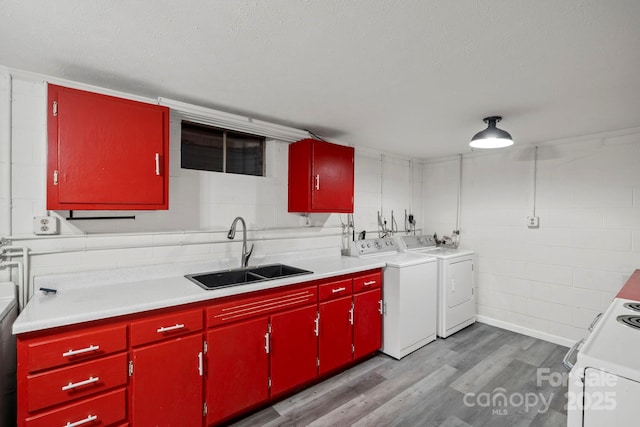 1 Ola Dr, Candler, NC 28715 - kitchen with red cabinets, a sink, independent washer and dryer, light wood finished floors, and light countertops