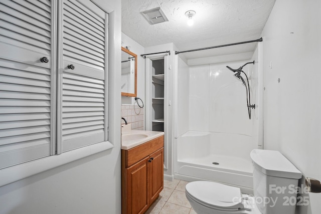 1 Ola Dr, Candler, NC 28715 - bathroom featuring tile patterned floors, toilet, a stall shower, vanity, and a textured ceiling