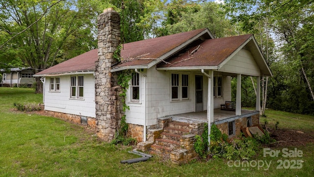 1 Ola Dr, Candler, NC 28715 - rear view of property with a chimney, a lawn, roof with shingles, and covered porch