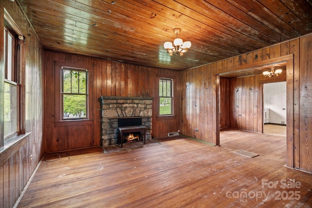 1 Ola Dr, Candler, NC 28715 - unfurnished living room featuring a chandelier, wood ceiling, hardwood / wood-style flooring, plenty of natural light, and wooden walls