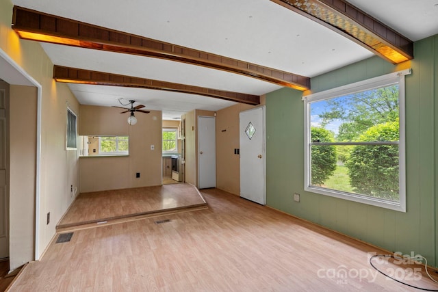 1 Ola Dr, Candler, NC 28715 - unfurnished living room featuring wood finished floors, a ceiling fan, and beamed ceiling