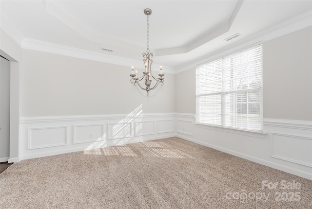 10008 King George Ln, Waxhaw, NC 28173 - empty room featuring a raised ceiling, healthy amount of natural light, carpet floors, a chandelier, and wainscoting