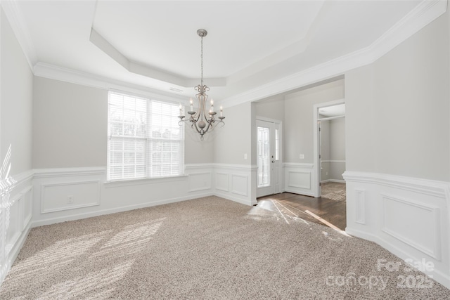 10008 King George Ln, Waxhaw, NC 28173 - unfurnished dining area with carpet, a chandelier, a raised ceiling, a decorative wall, and wainscoting