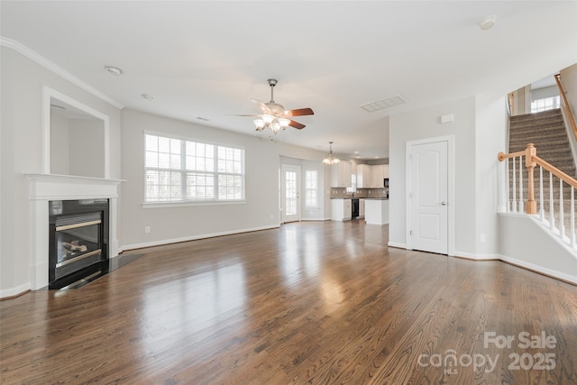 10008 King George Ln, Waxhaw, NC 28173 - unfurnished living room with stairs, a ceiling fan, a glass covered fireplace, baseboards, and dark wood finished floors
