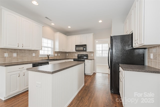 10008 King George Ln, Waxhaw, NC 28173 - kitchen featuring black appliances, healthy amount of natural light, dark countertops, white cabinets, and recessed lighting