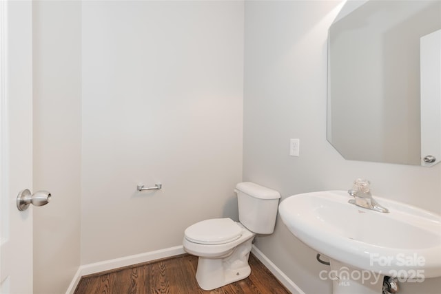 10008 King George Ln, Waxhaw, NC 28173 - half bath featuring baseboards, a sink, wood finished floors, and toilet