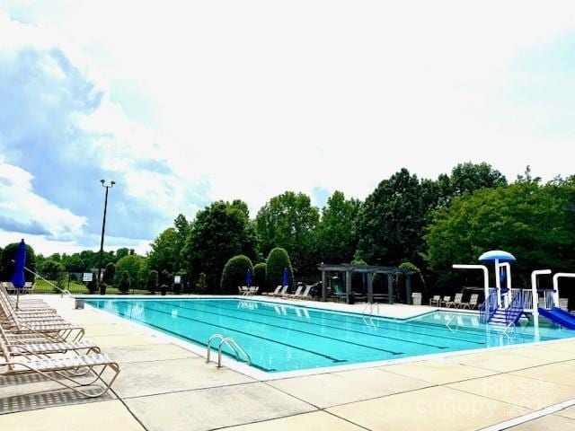 10008 King George Ln, Waxhaw, NC 28173 - community pool featuring a patio area and view of scattered trees