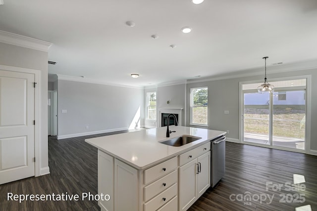 kitchen with a sink, crown molding, open floor plan, dishwasher, and baseboards