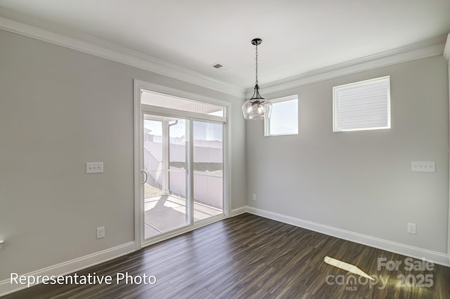 unfurnished dining area with crown molding, dark wood finished floors, and baseboards