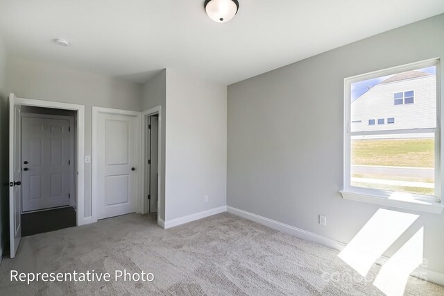 unfurnished bedroom with carpet and baseboards