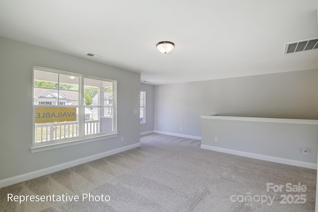 unfurnished room with carpet and baseboards
