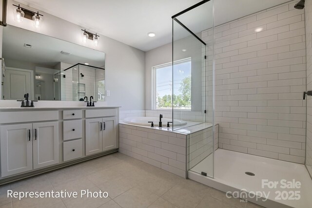 full bathroom featuring a shower stall, tile patterned flooring, a garden tub, and double vanity