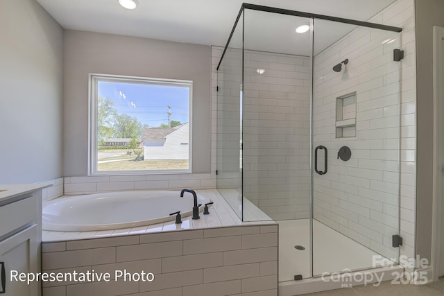 bathroom with a garden tub, a shower stall, vanity, and recessed lighting