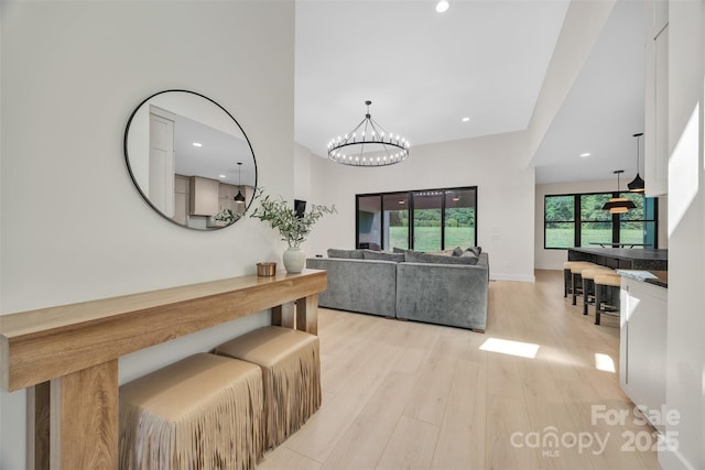 1141 Harper Lee Dr, Newton, NC 28658 - hall with light wood finished floors, a chandelier, and recessed lighting