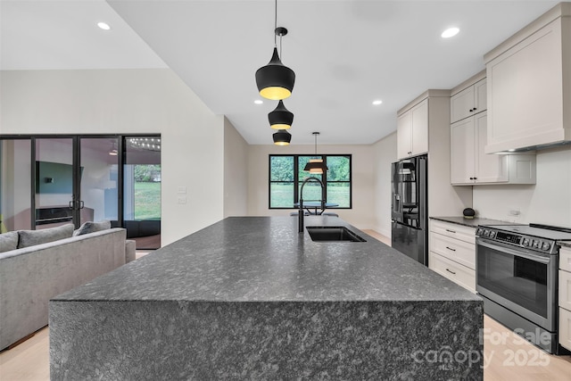 1141 Harper Lee Dr, Newton, NC 28658 - kitchen featuring stainless steel electric range, refrigerator with ice dispenser, light wood finished floors, a large island with sink, and recessed lighting