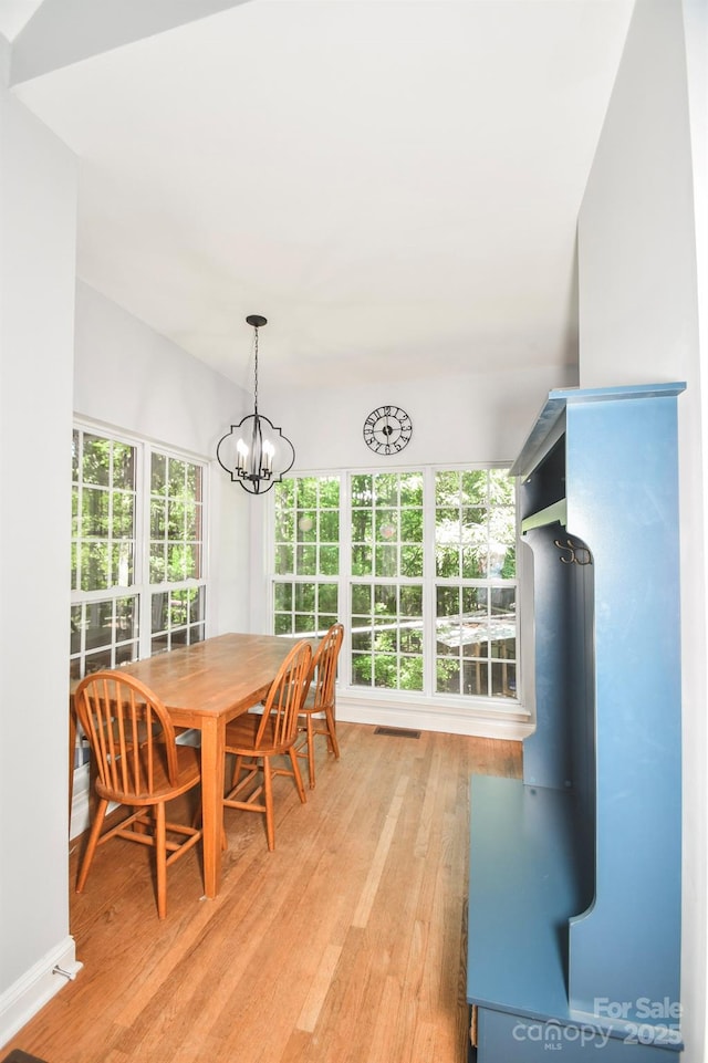 7328 S Providence Rd, Waxhaw, NC 28173 - dining room featuring light wood finished floors and a chandelier