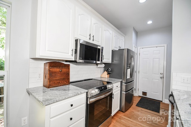 7328 S Providence Rd, Waxhaw, NC 28173 - kitchen with stainless steel appliances, light wood-type flooring, white cabinetry, recessed lighting, and tasteful backsplash