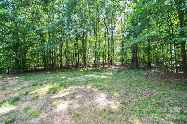 7328 S Providence Rd, Waxhaw, NC 28173 - view of yard featuring fence and a wooded view