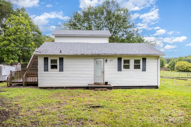 view of front facade featuring a shingled roof, crawl space, and stairs