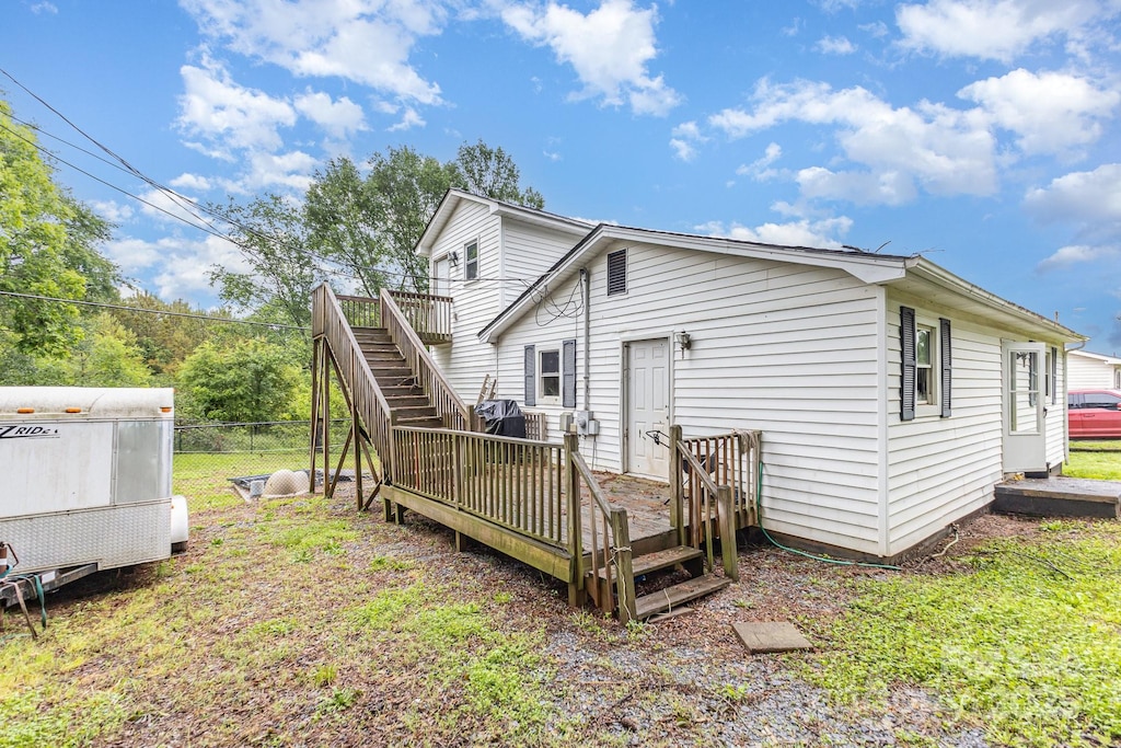 rear view of house with a deck and stairway