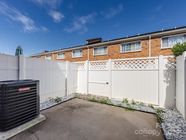 view of patio / terrace with central AC unit and a fenced backyard