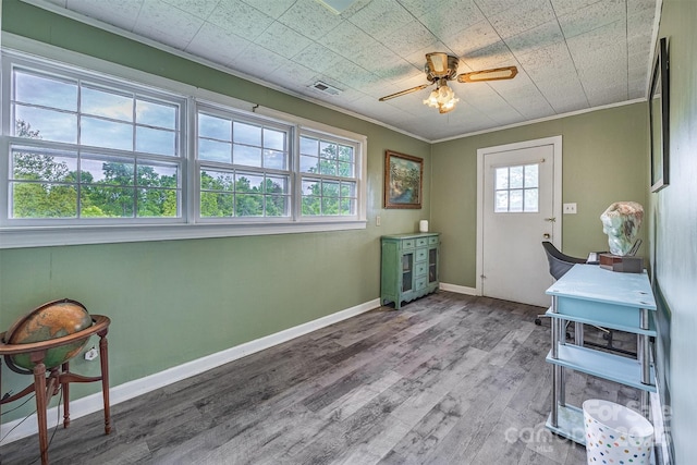 office with crown molding, wood finished floors, ceiling fan, and baseboards