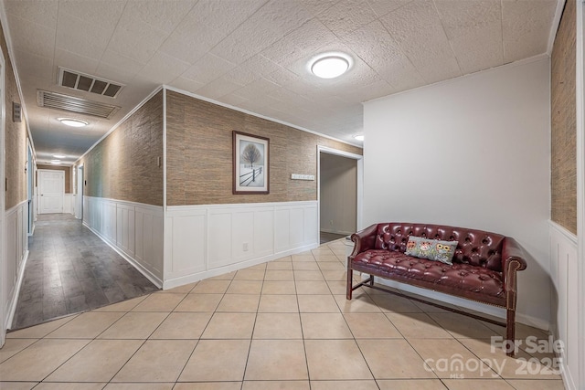 hallway with wainscoting and crown molding