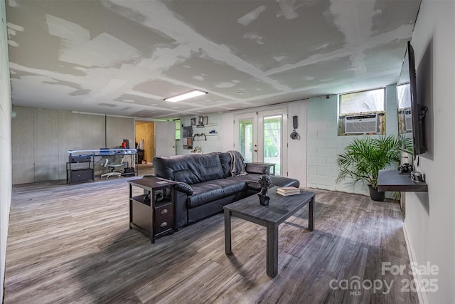 living room featuring wood finished floors and cooling unit