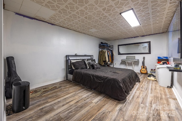 bedroom with wood finished floors and baseboards