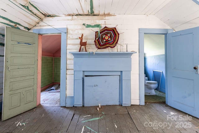 detailed view of wood finished floors and a fireplace