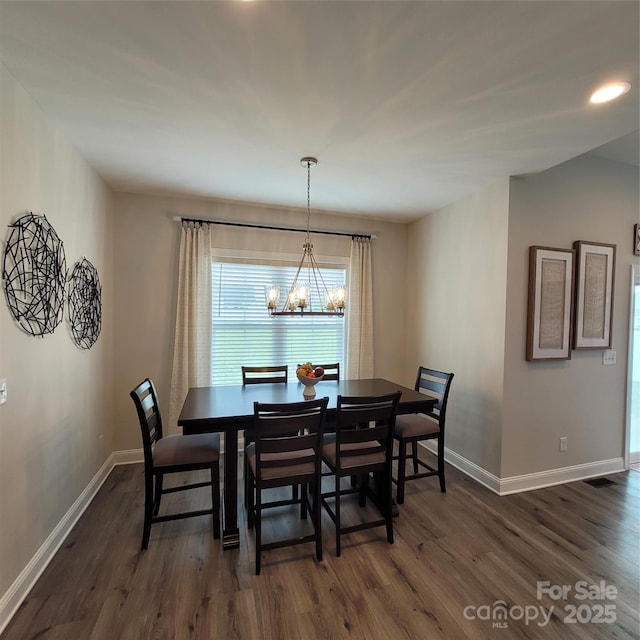 5118 Regents Park Dr, Hickory, NC 28602 - dining space with a chandelier, dark wood finished floors, and baseboards