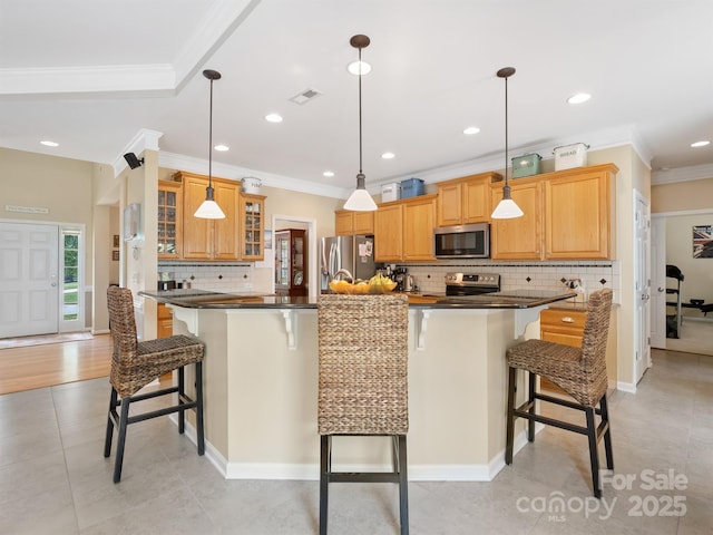7627 Woodcrest Dr, Stanley, NC 28164 - kitchen with appliances with stainless steel finishes, dark countertops, a breakfast bar, tasteful backsplash, and crown molding