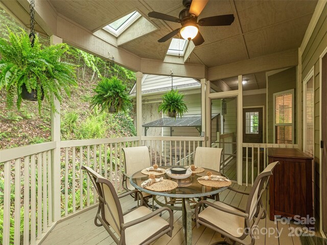 sunroom / solarium featuring a skylight and a ceiling fan