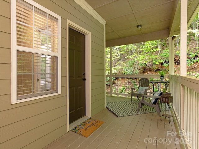 view of exterior entry with covered porch