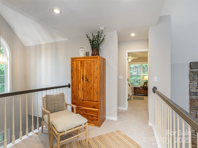 sitting room with an upstairs landing, light colored carpet, baseboards, a ceiling fan, and recessed lighting