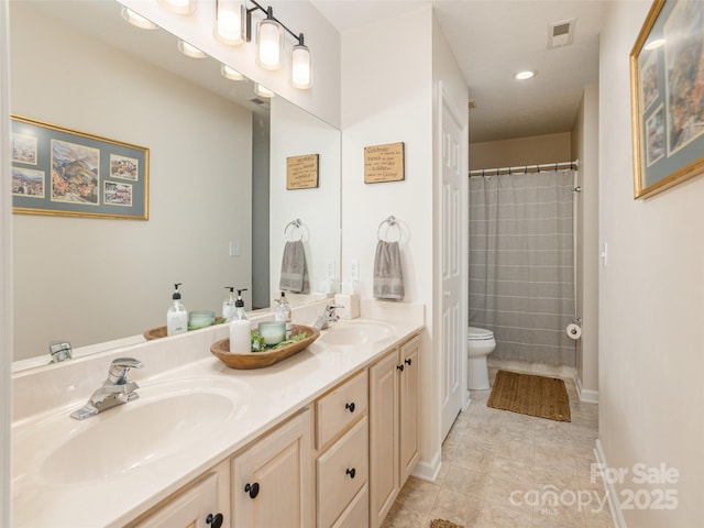 bathroom featuring double vanity, toilet, tile patterned flooring, recessed lighting, and baseboards