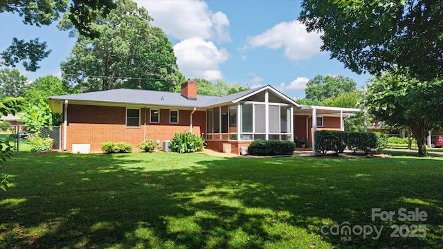 6003 Woodbridge Rd, Charlotte, NC 28227 - back of property with a sunroom, brick siding, and a chimney