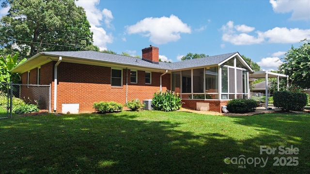 6003 Woodbridge Rd, Charlotte, NC 28227 - back of property featuring brick siding, a sunroom, and a chimney