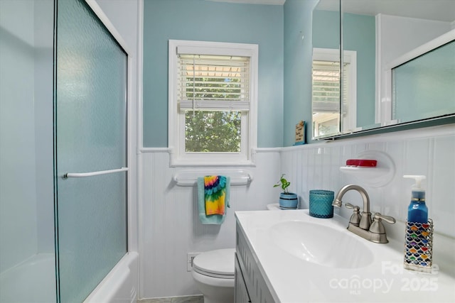 6003 Woodbridge Rd, Charlotte, NC 28227 - bathroom featuring wainscoting, vanity, and shower / bath combination with glass door