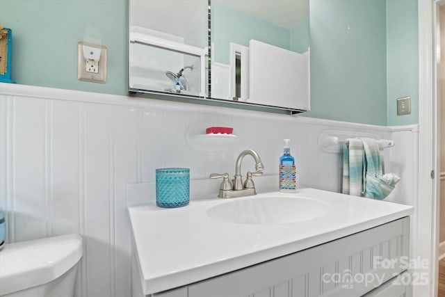 6003 Woodbridge Rd, Charlotte, NC 28227 - bathroom with vanity, a wainscoted wall, and a decorative wall