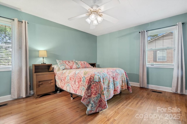 6003 Woodbridge Rd, Charlotte, NC 28227 - bedroom featuring wood finished floors, multiple windows, and a ceiling fan