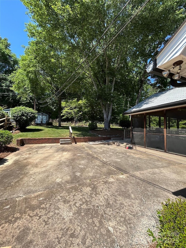 view of home's community with a patio area, a storage unit, an outdoor structure, a lawn, and view of scattered trees