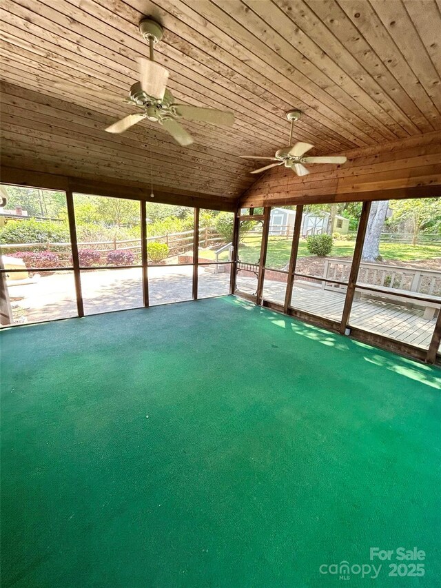 unfurnished sunroom featuring ceiling fan