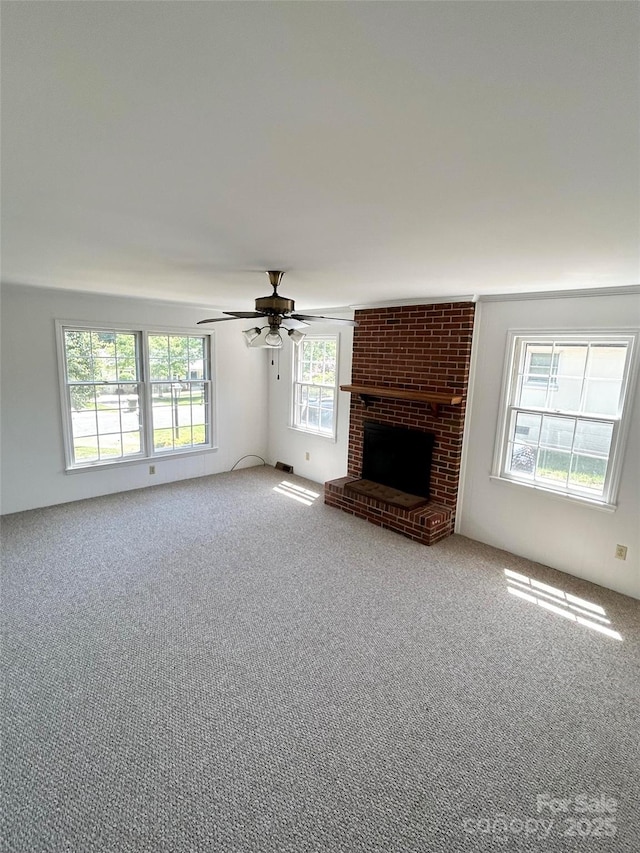 unfurnished living room featuring carpet flooring, ceiling fan, and a fireplace