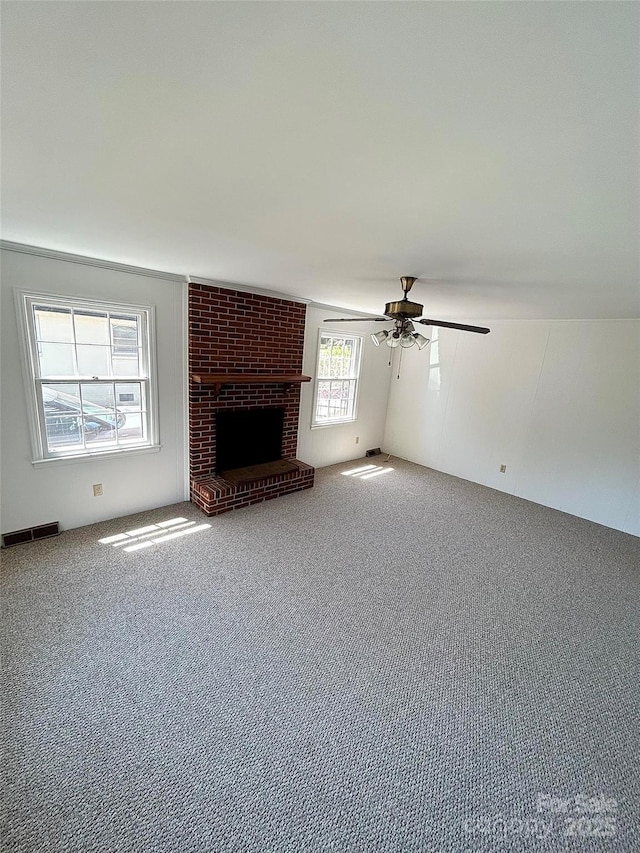 unfurnished living room featuring carpet floors, ceiling fan, and a fireplace
