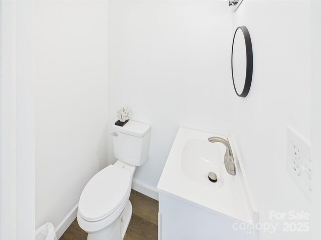 120 Hepler Rd, Taylorsville, NC 28681 - half bathroom with baseboards, toilet, and vanity