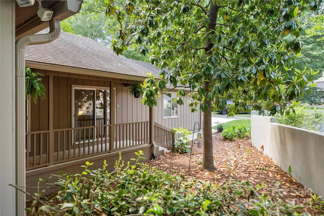 property entrance with roof with shingles