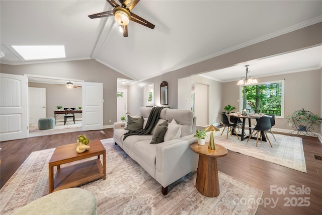 living room with wood finished floors, ceiling fan, baseboards, a chandelier, and lofted ceiling